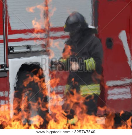 Firefighter And The Hot Flame Of The Fire During The Drill