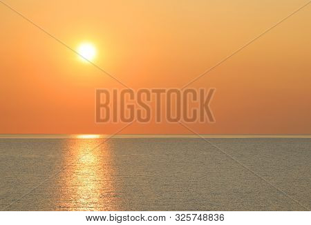 Hot Yellow Sun Over The Ocean At Sundown