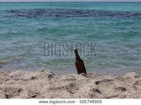 Bottle On The Sandy Beach By The Ocean Perhaps With A Secret Map