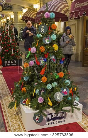 Moscow, Russia - December 2, 2018: Christmas Trees With Symbols Of Various Companies In Gum. Christm