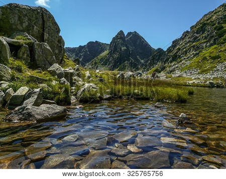 Mountain Landscape And Glacial Taul Portii Lake In Retezat National Park, Carpathian Mountains, Roma