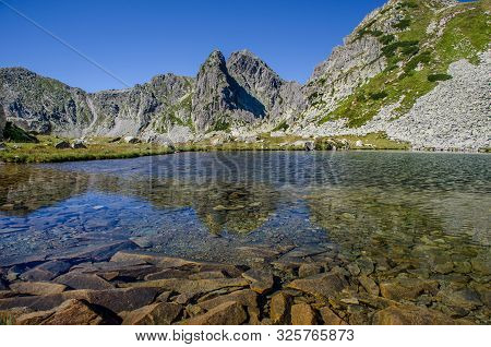 Mountain Landscape And Glacial Taul Portii Lake In Retezat National Park, Carpathian Mountains, Roma