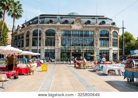 PERPIGNAN, FRANCE - SEPTEMBER 14, 2019: A view of the Catalogne Square in Perpignan, France, highlighting the Aux Dames de France building, a former department store, converted into a shopping mall