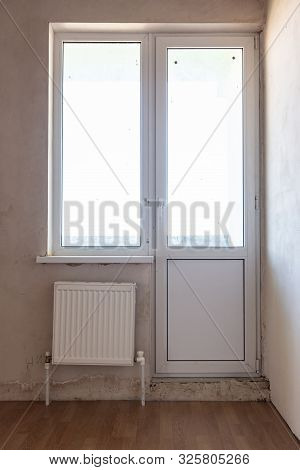 Exit To The Balcony In The Interior Of An Unrepaired Room