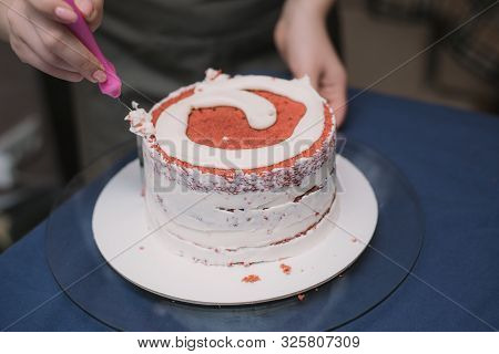 The Confectioner Levels The Cream On The Cake. The Cook Creates A Cake, Collects It And Covers It Wi