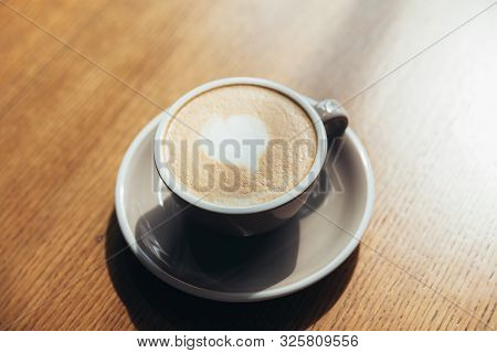 Coffee Cup Fresh Cream Organic Cappuccino On Table In Cafe. Latte Macchiato Drink In Glass Close Up.