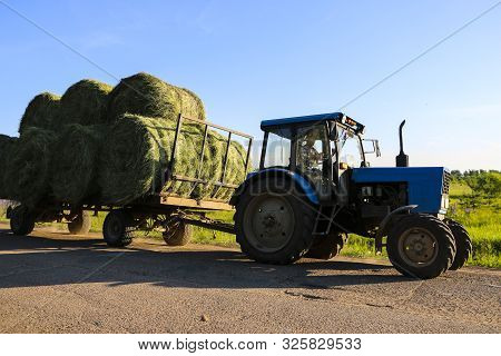 Tractor Driven Fresh Hay Rolled, After Seasonal Harvesting