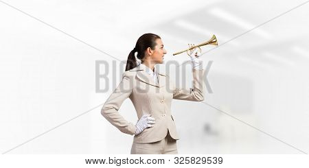 Business Woman Playing Trumpet Brass. Young Lady In White Business Suit And Gloves Posing With Music