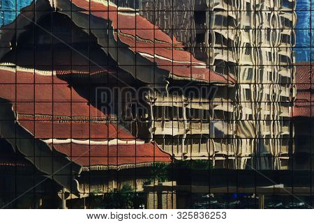 Modern Building Curtain Wall Reflecting Retro Traditional Style Building In The Facade. Clean Glasse