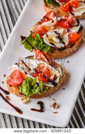 Bruschetta With Tomatoes, Lettuce, Camambert, Balsamic Vinegar
