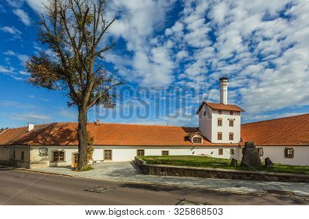 Dacice, Czech Republic - September 29 2019: View Of Former Brewery Building With White Facade, Red R