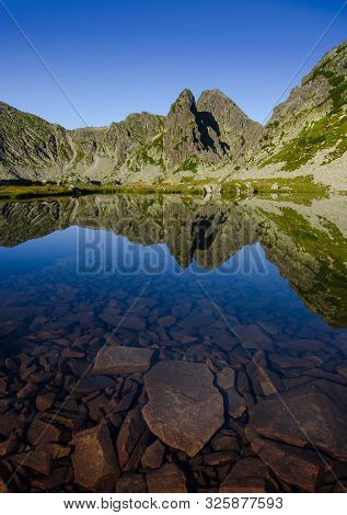 Mountain Landscape And Glacial Taul Portii Lake In Retezat National Park, Carpathian Mountains, Roma