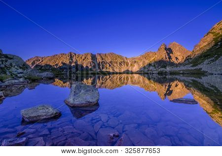 Mountain Landscape And Glacial Taul Portii Lake In Retezat National Park, Carpathian Mountains, Roma
