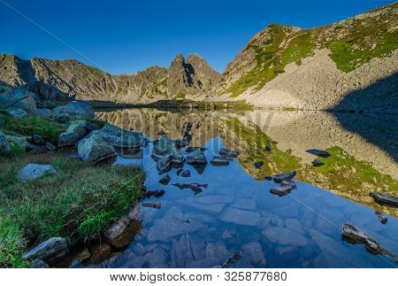 Mountain Landscape And Glacial Taul Portii Lake In Retezat National Park, Carpathian Mountains, Roma