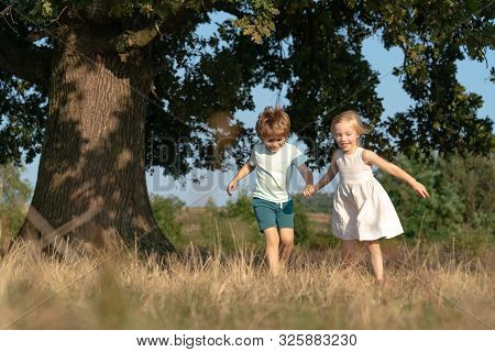 Children Run On Field. Children Farmer Concept. Happy Children Farmers Working With Spud On Spring F