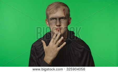 Executioner Halloween Man Portrait. Guy With Dripping Blood On His Face. Executioner, Headman Makeup