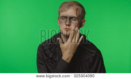 Executioner Halloween Man Portrait. Guy With Dripping Blood On His Face. Executioner, Headman Makeup