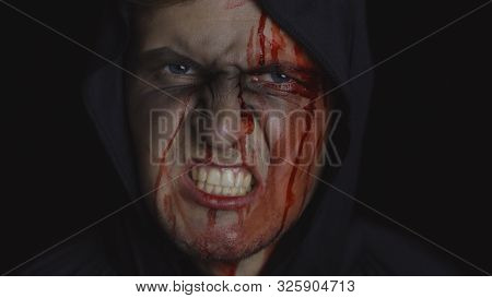 Executioner Halloween Man Portrait. Angry Aggressive Guy With Dripping Blood On His Face. Executione