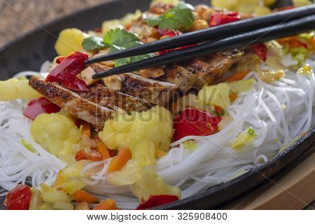 Steaming Hot Sizzler On Wood With Sticks