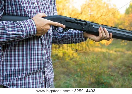 Male With Semi-automated Shotgun In The Autumn Forest Ready To Hunting, Close Up View