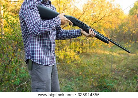 Male With Semi-automated Shotgun In The Autumn Forest Ready To Hunting, Close Up View