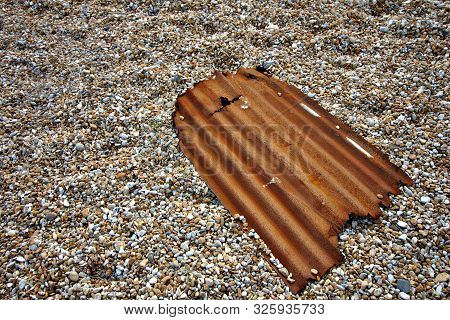 Corrugated Iron Sheet Left Over At A Pebble Beach