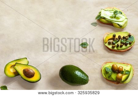 Green Vegan Food Avacado Sandwich On White Beeswax Wraps Paper With Fresh Sliced Whole Avocados And 