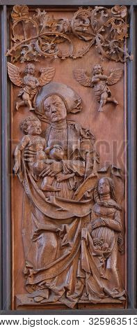ROTHENBURG, GERMANY - JULY 16, 2019: Saint Anne, Child and Virgin Mary, Coronation of Mary altar in St James Church in Rothenburg ob der Tauber, Germany