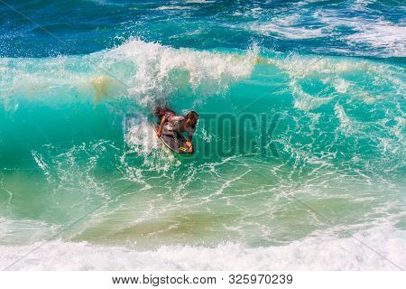 Sydney, Australia - March 16th 2013: Man Surfing On A Wave. The Sport Is Very Poular.