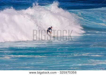 Sydney, Australia - March 16th 2013: Man Surfing On A Wave. The Sport Is Very Poular.