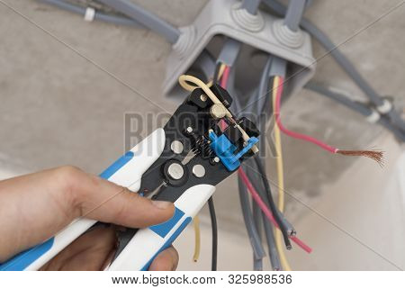 Electrician Strips Wires