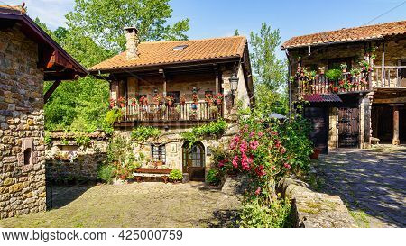 Picturesque Stone Houses In Mountain Village With Plants And Flowers. Barcena Mayor.