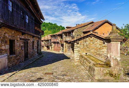 Ancient Stone Houses And Ancient Water Fountain On The Street. Barcena Mayor Santander.