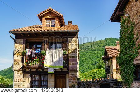 Balconies Of Old Stone Houses With Clothes Hanging In The Sun.
