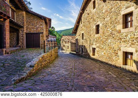 Stone Houses And Narrow Alley In Mountain Village In Northern Spain. Barcena Mayor.