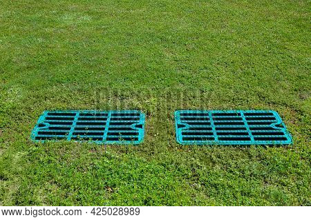 Manhole Drainage Grates On The Lawn With Green Grass Septic Tank Cover, Sump Cesspool Drainage Syste
