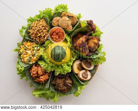 Nasi Tumpeng. Indonesian Cuisine Yellow Rice On Banana Leaf