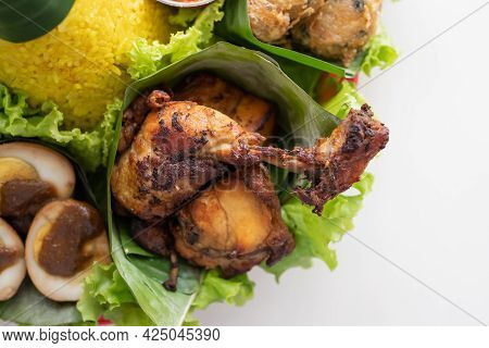 Nasi Tumpeng. Indonesian Cuisine Yellow Rice On Banana Leaf