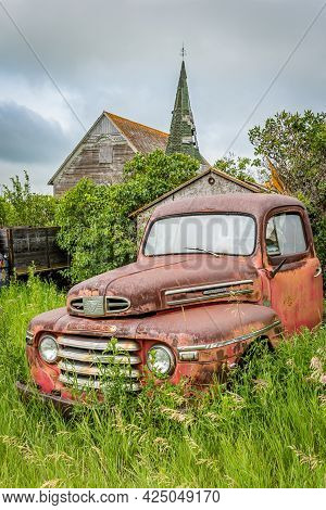 Weyburn, Sk- July 19, 2020:  Classic Red Mercury M Series Pickup Truck Abandoned With The Froude Pre
