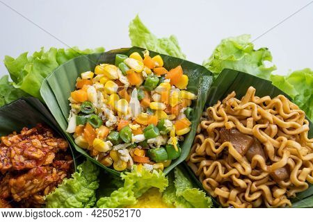 Nasi Tumpeng. Indonesian Cuisine Yellow Rice On Banana Leaf