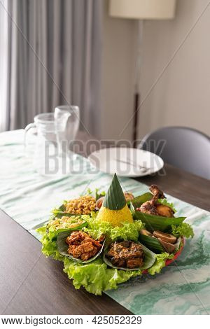 Nasi Tumpeng. Indonesian Cuisine Yellow Rice On Banana Leaf