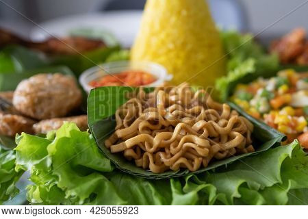 Nasi Tumpeng. Indonesian Cuisine Yellow Rice On Banana Leaf