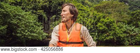 Banner, Long Format Man Tourist In Trang An Scenic Landscape Complex In Ninh Binh Province, Vietnam 