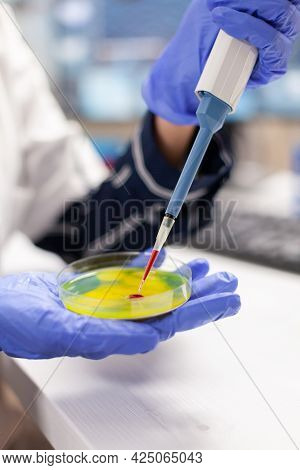 Close Up Of Doctor Dropping Blood Sample Using Micropipette In Medicine Lab. Medical Stuff Examining