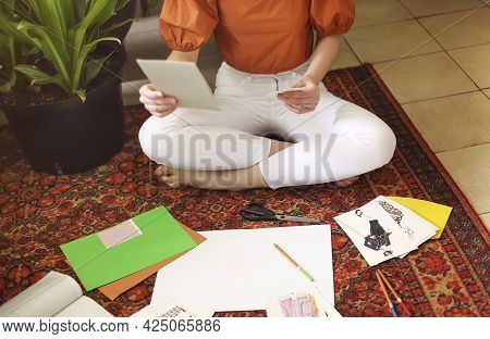 Young Woman Creating Her Feng Shui Wish Mapsitting On The Carpet In The Room In Boho Style With A Lo