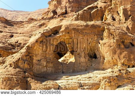 Arch as a result of weathering. Magnificent multi-colored rocks The Timna Valley in the south of the Arava Desert, near the resort of Eilat. Israel. Hot November day. 