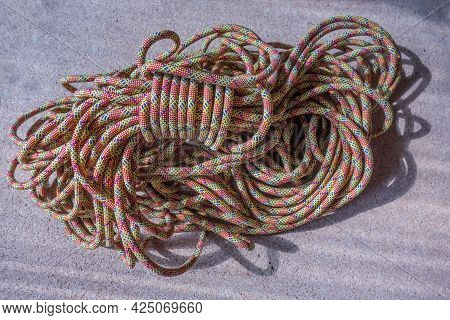 Multi-colored Rock Climbing Ropes In Bundles. Macro Detail Of A Nylon Rope. Background Of The Coiled