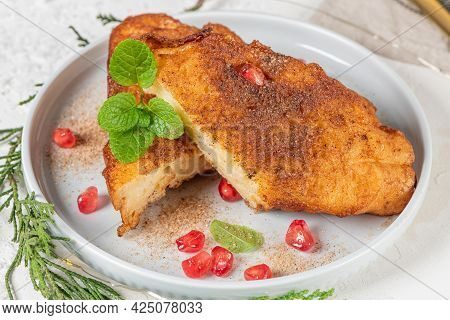 Traditional Christmas Rabanadas With Lemon Zest, Pomegranate, Pine Nuts And Cinnamon. Spanish Torrij