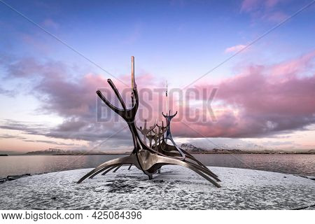 Reykjavik, Iceland. - 17 January 2020: The Sun Voyager, a modern sculpture by Jon Gunnar Arnason, of a viking ship. Sunset in Reykjavik, Iceland. 