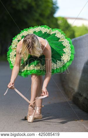 Dancing Concepts. Portrait Of Professional Caucasian Ballet Dancer In Green Tutu Dress Making Up Her